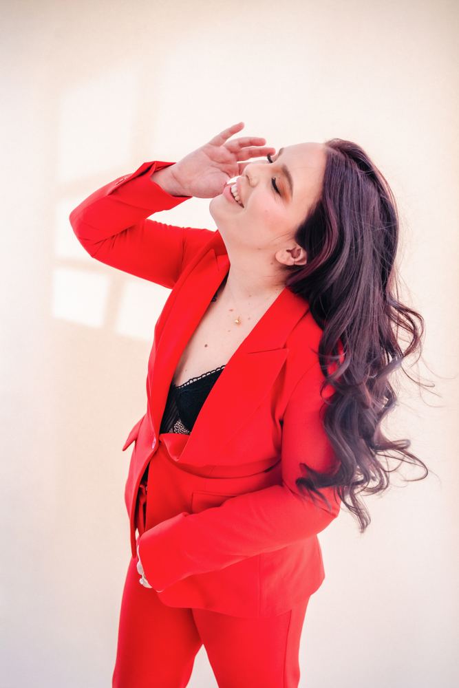 Sydney Mohni smiling in a red suit